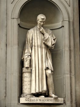 Intricate statue of Niccolò Machiavelli at the Uffizi Gallery in Florence, a masterpiece of Renaissance sculpture.