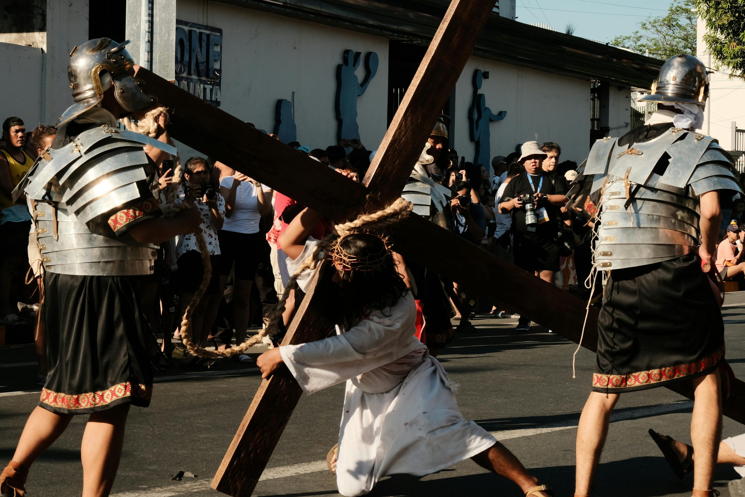 A powerful street performance depicting Jesus carrying the cross during a religious event in the Philippines.